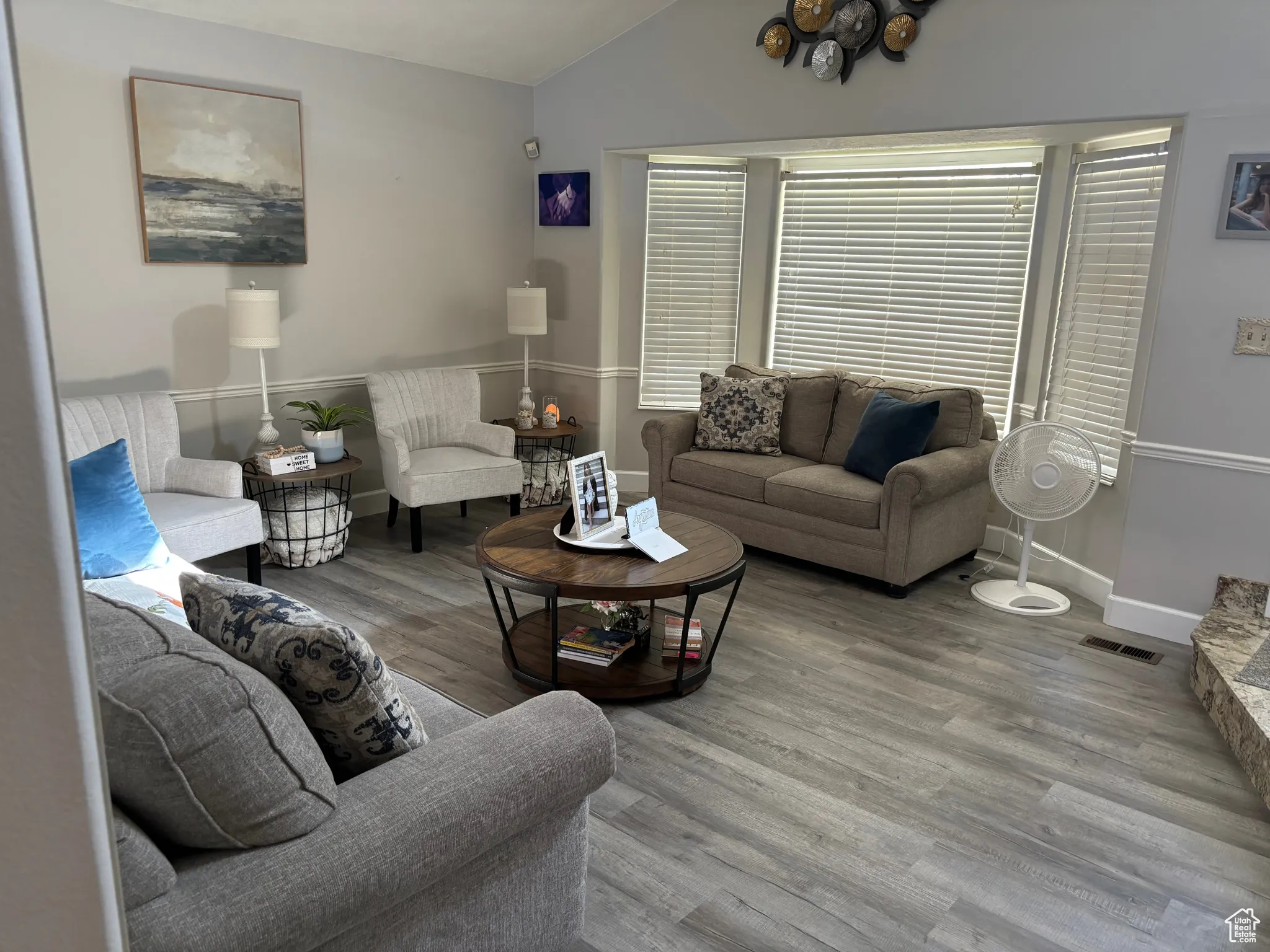 Living area with vaulted ceiling and wood finished floors