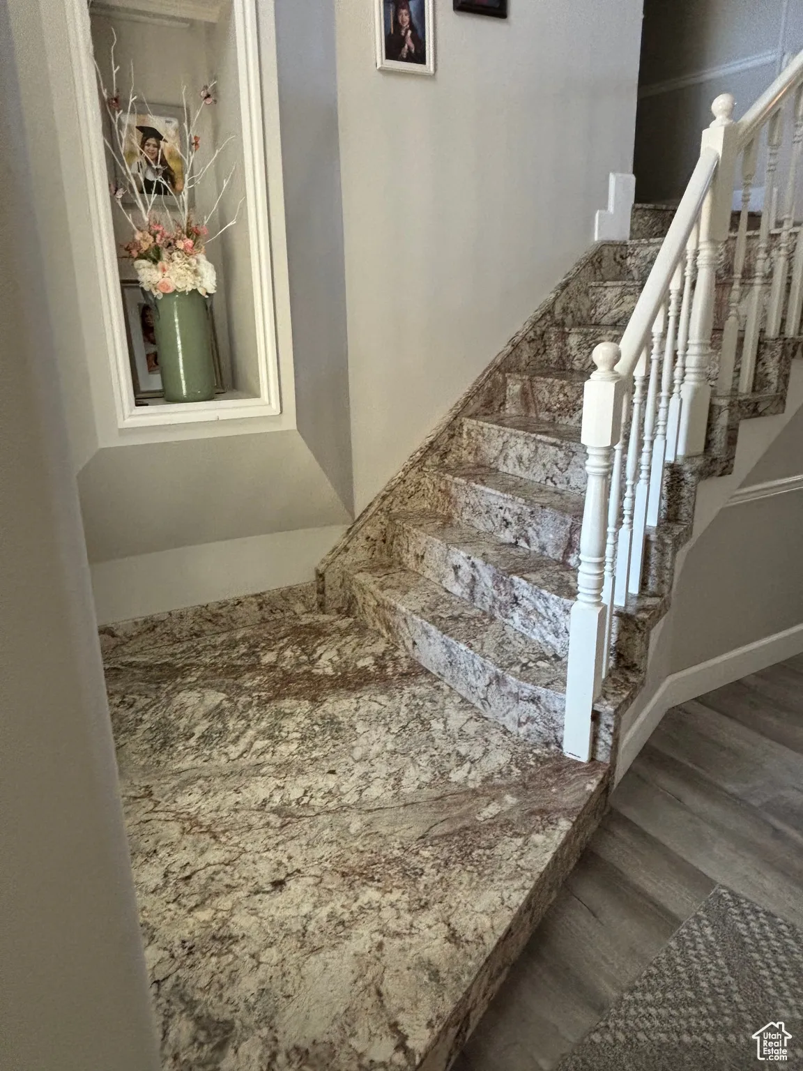 Staircase featuring wood finished floors and baseboards