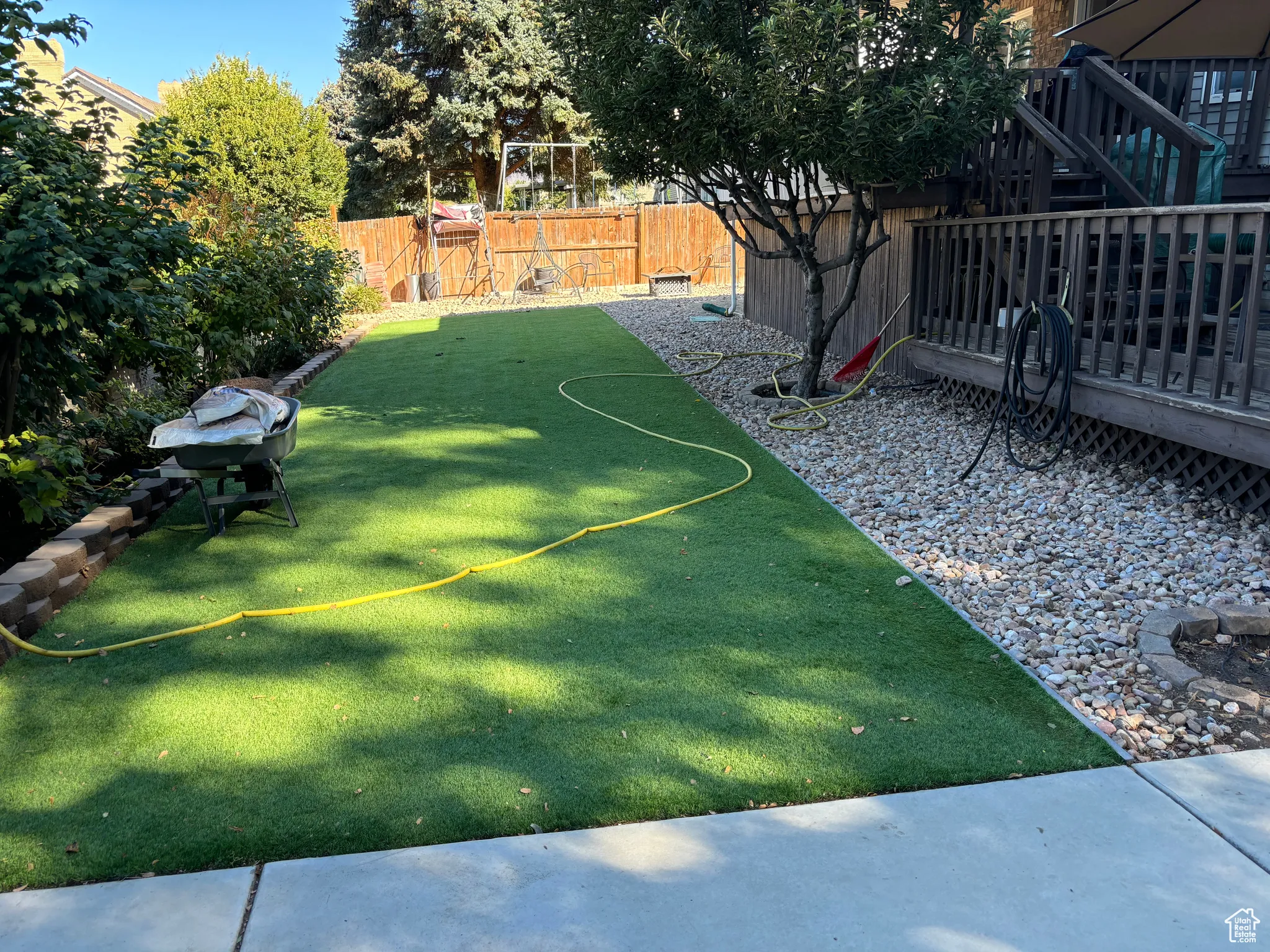 Fenced backyard featuring a deck