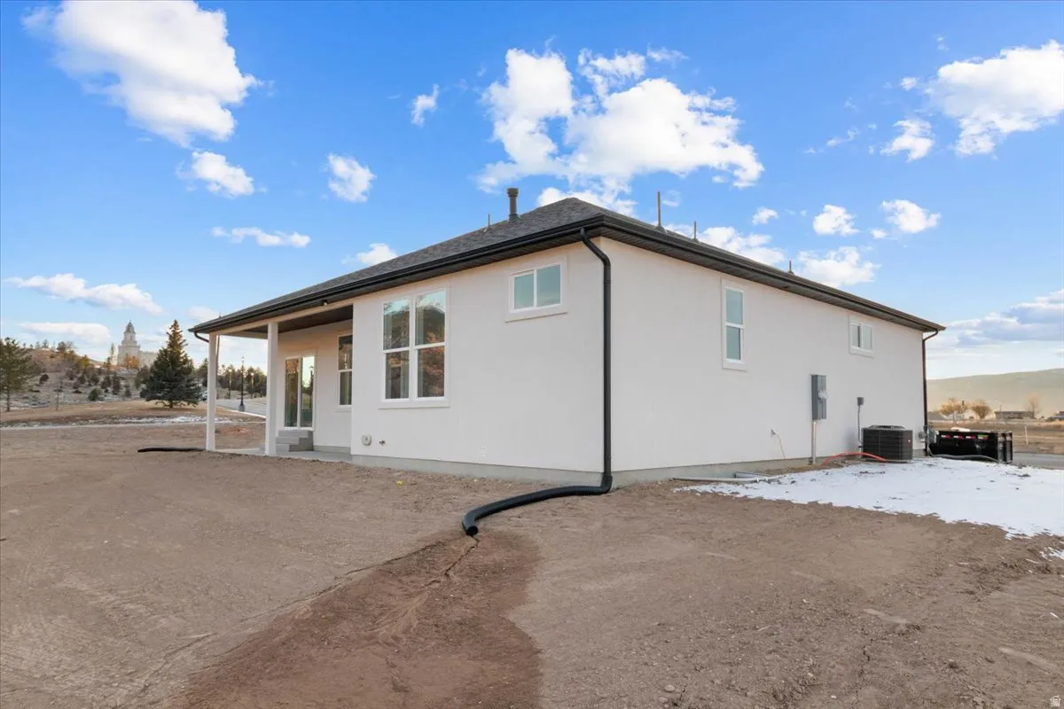 Back of house featuring a patio and stucco siding