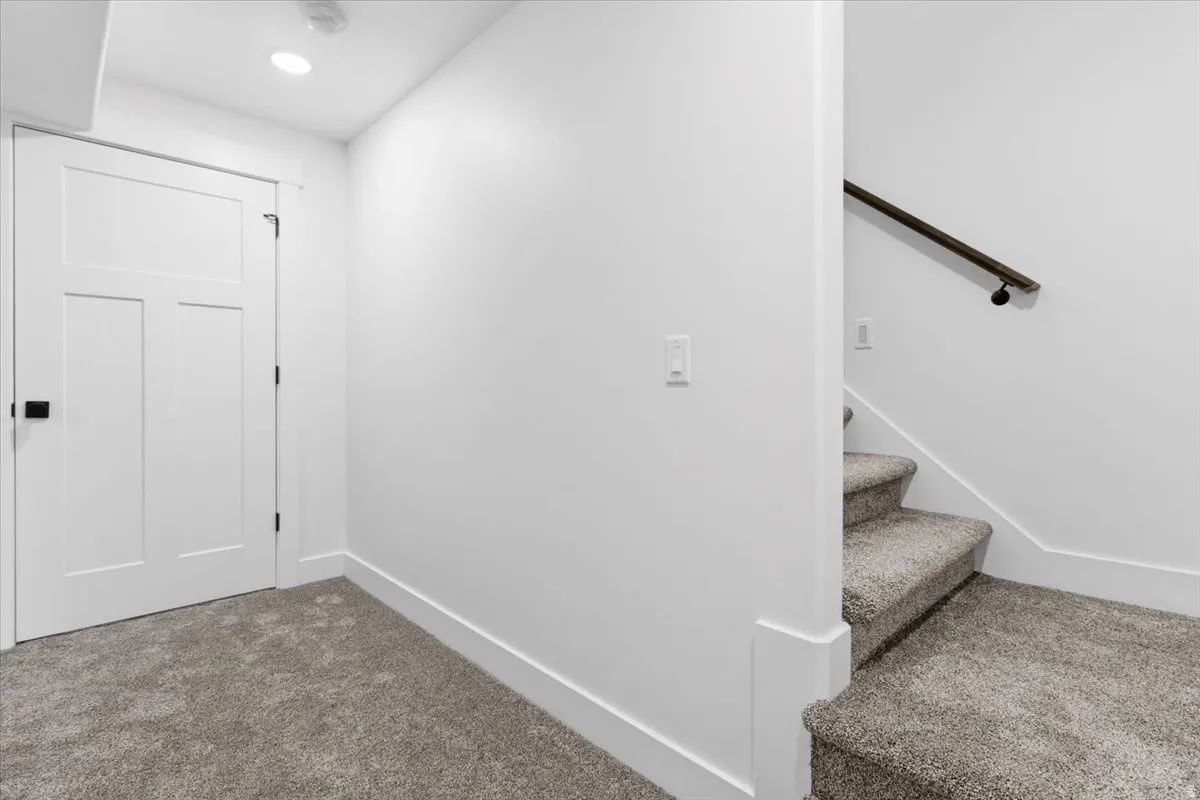 Staircase featuring carpet flooring and baseboards