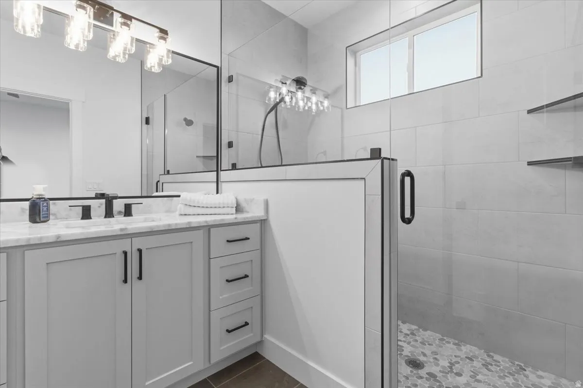 Full bath with a stall shower and vanity