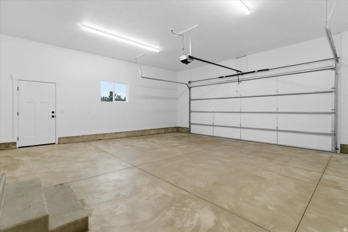 Garage featuring a garage door opener