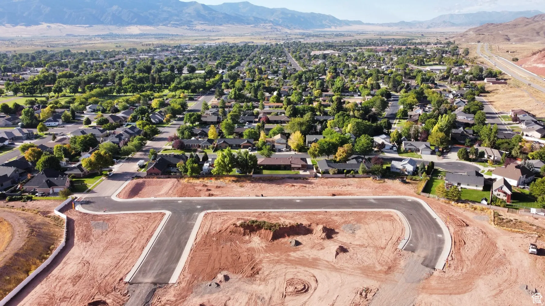 Aerial perspective of suburban area with a mountainous background