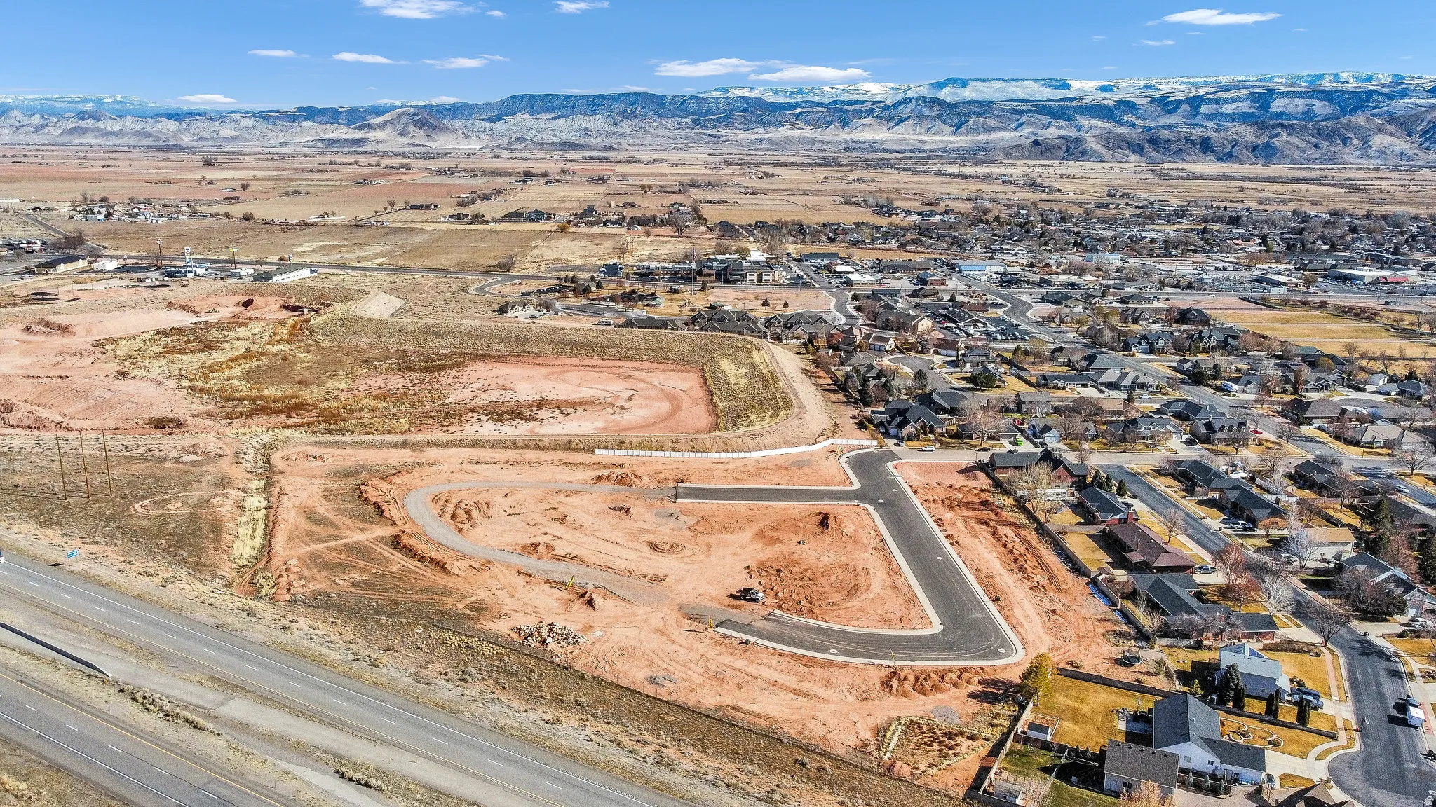 View of property location featuring mountains and nearby suburban area