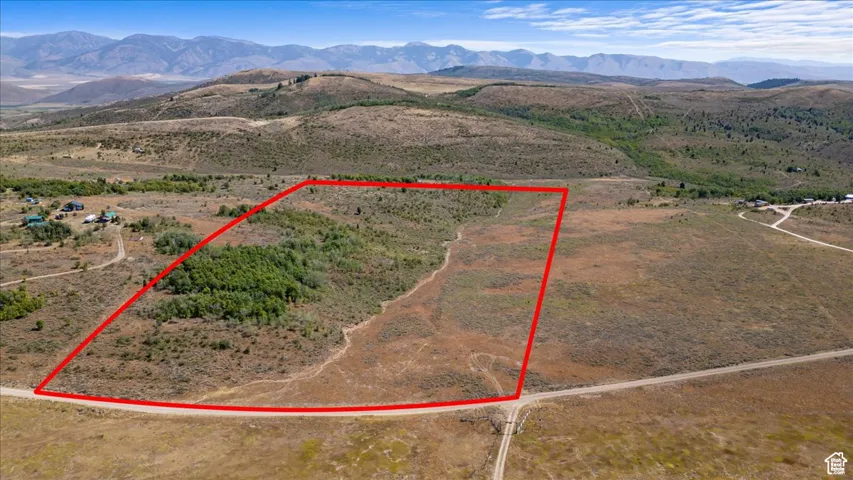 View of rural area with property boundaries highlighted and a mountainous background