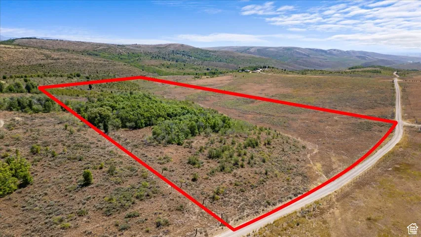 Aerial view of sparsely populated area with property boundaries highlighted and mountains