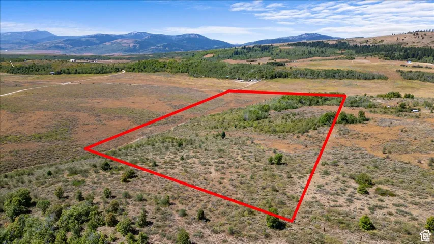 View of rural area with property boundaries highlighted and a mountainous background