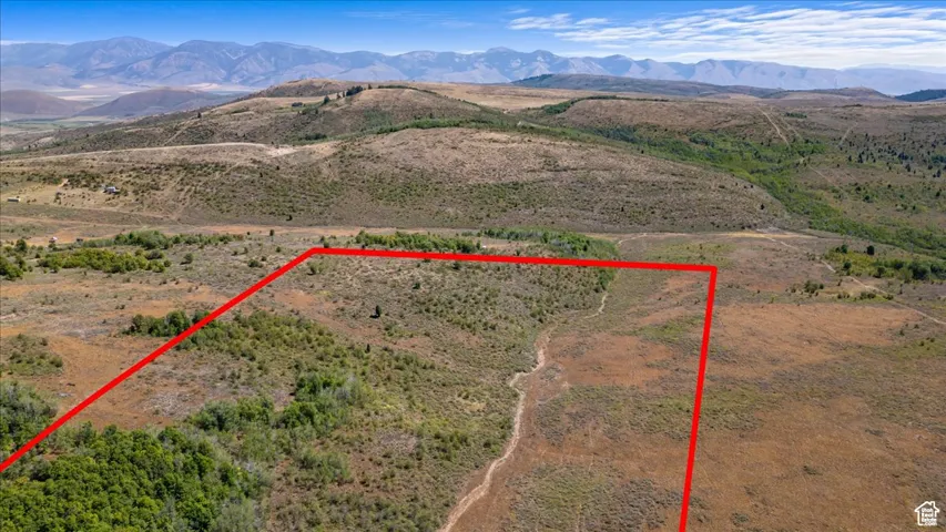 Aerial overview of property's location featuring property parcel outlined and mountains