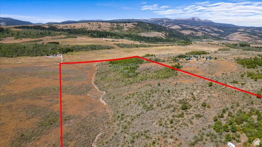 View of rural area featuring a mountain backdrop and property boundaries highlighted