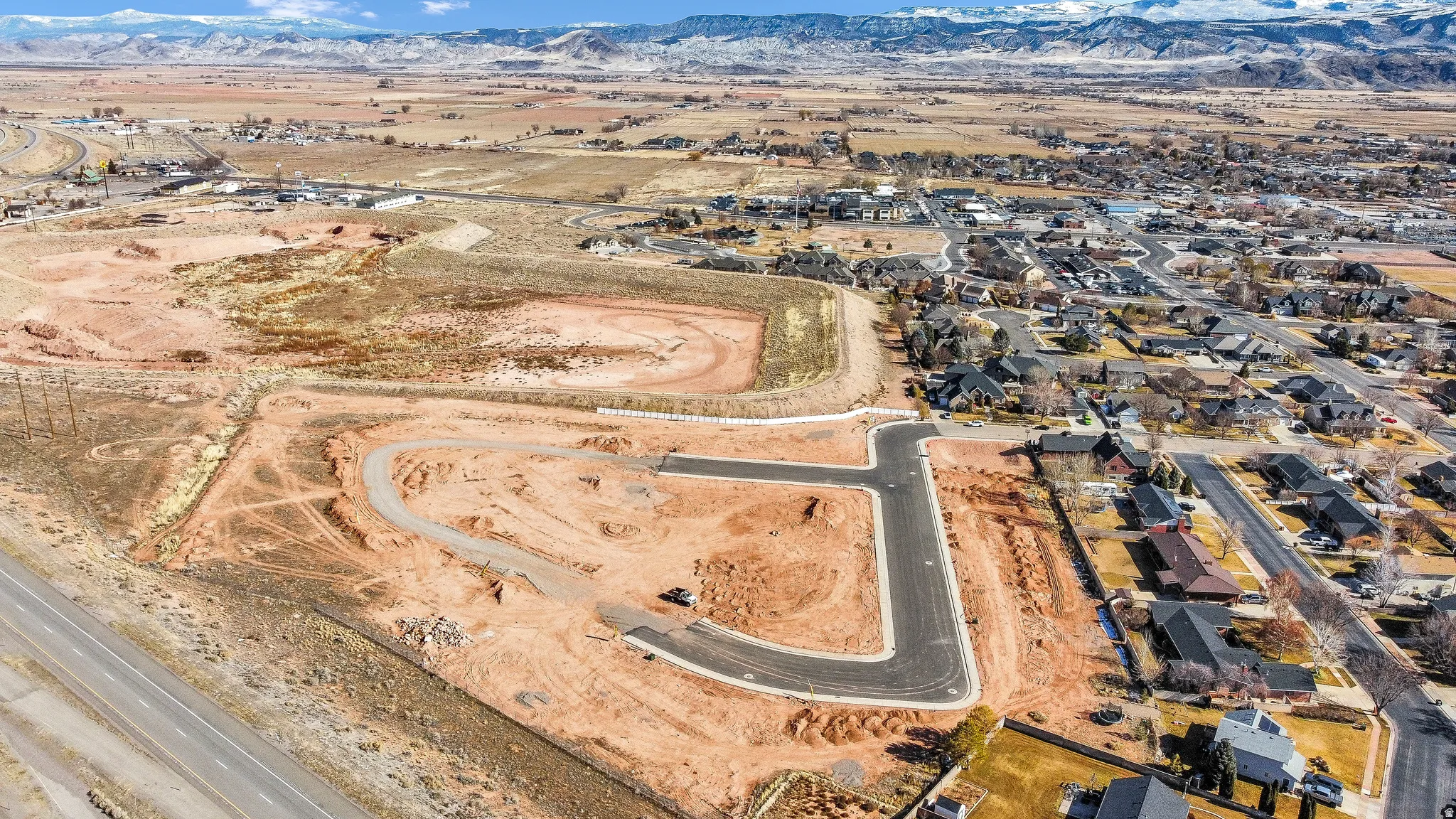 Aerial overview of property's location featuring nearby suburban area and mountains