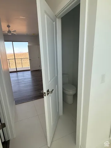 Bathroom featuring light tile patterned floors and a ceiling fan