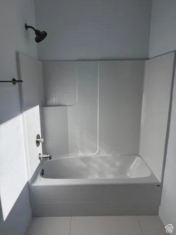 Full bathroom with tile patterned floors and  shower combination