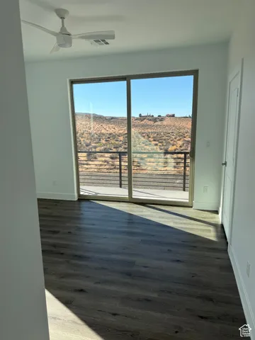 Unfurnished room featuring wood finished floors and a ceiling fan