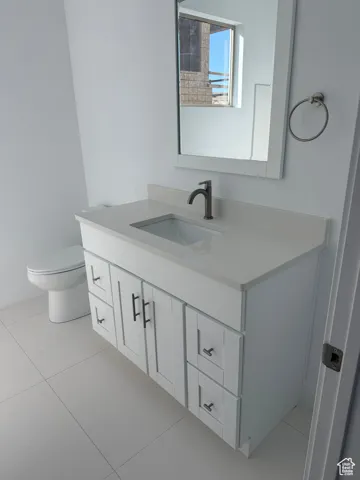 Full bath featuring light tile patterned floors and vanity