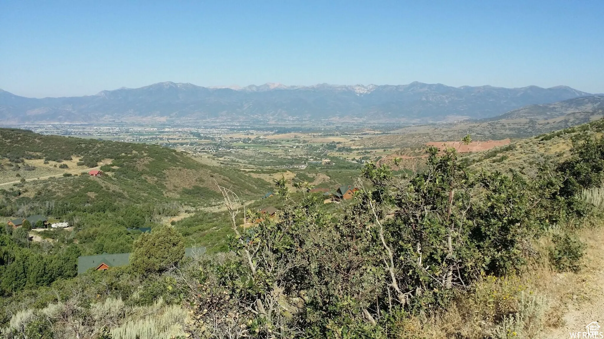 View of mountain background featuring a heavily wooded area