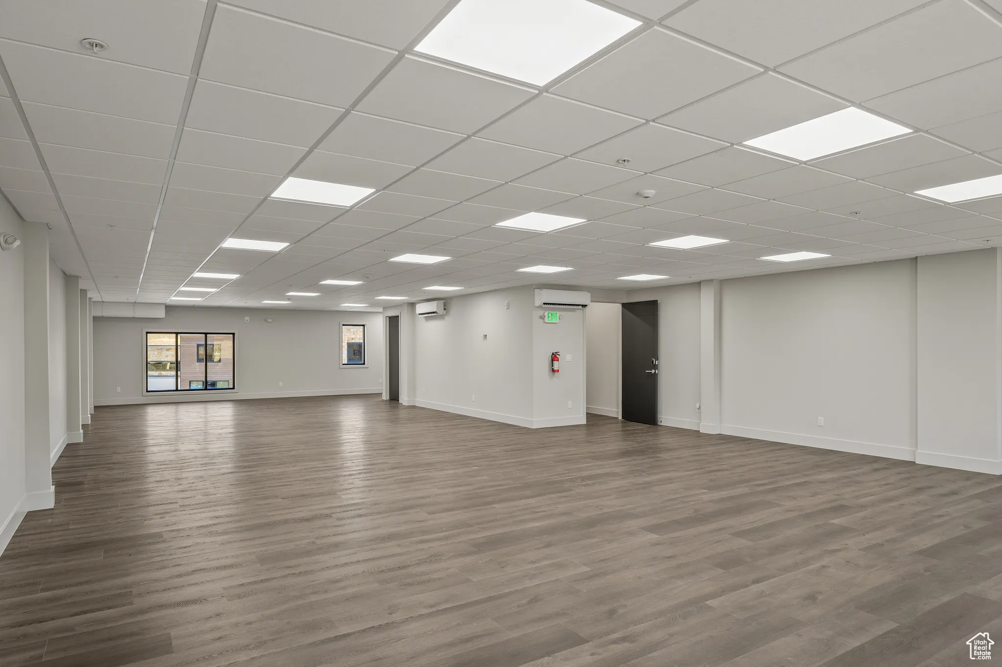 Unfurnished room featuring wood finished floors and a paneled ceiling