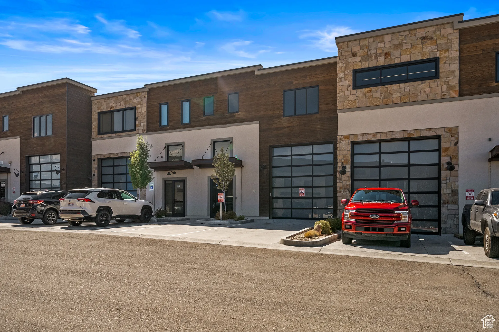 View of front of home featuring stone siding and stucco siding