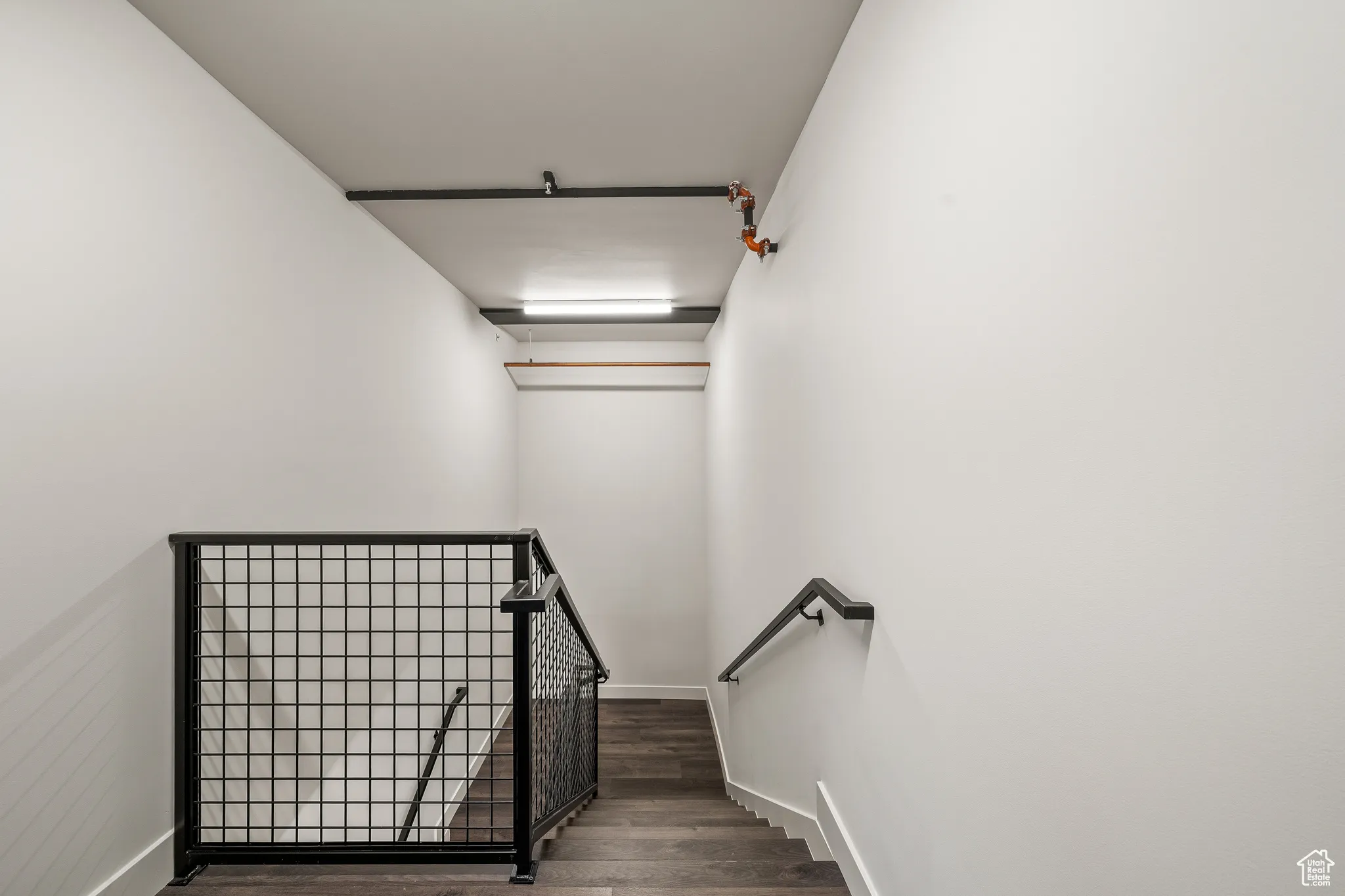 Staircase featuring wood finished floors and baseboards