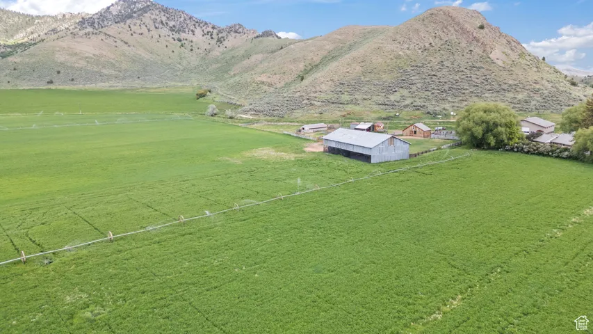 View of rural area featuring a mountain backdrop and agricultural land
