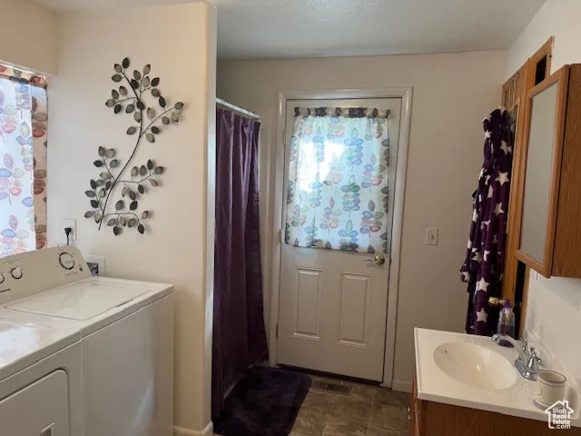 Laundry room with washer and clothes dryer