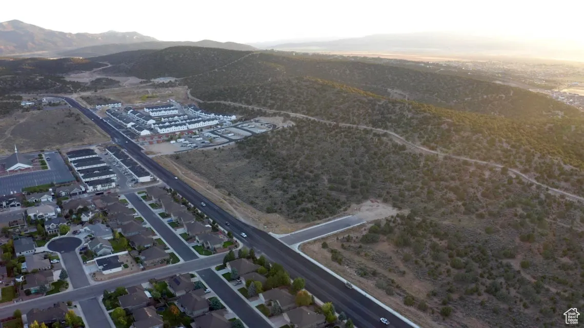 Aerial view of property's location featuring a mountain backdrop