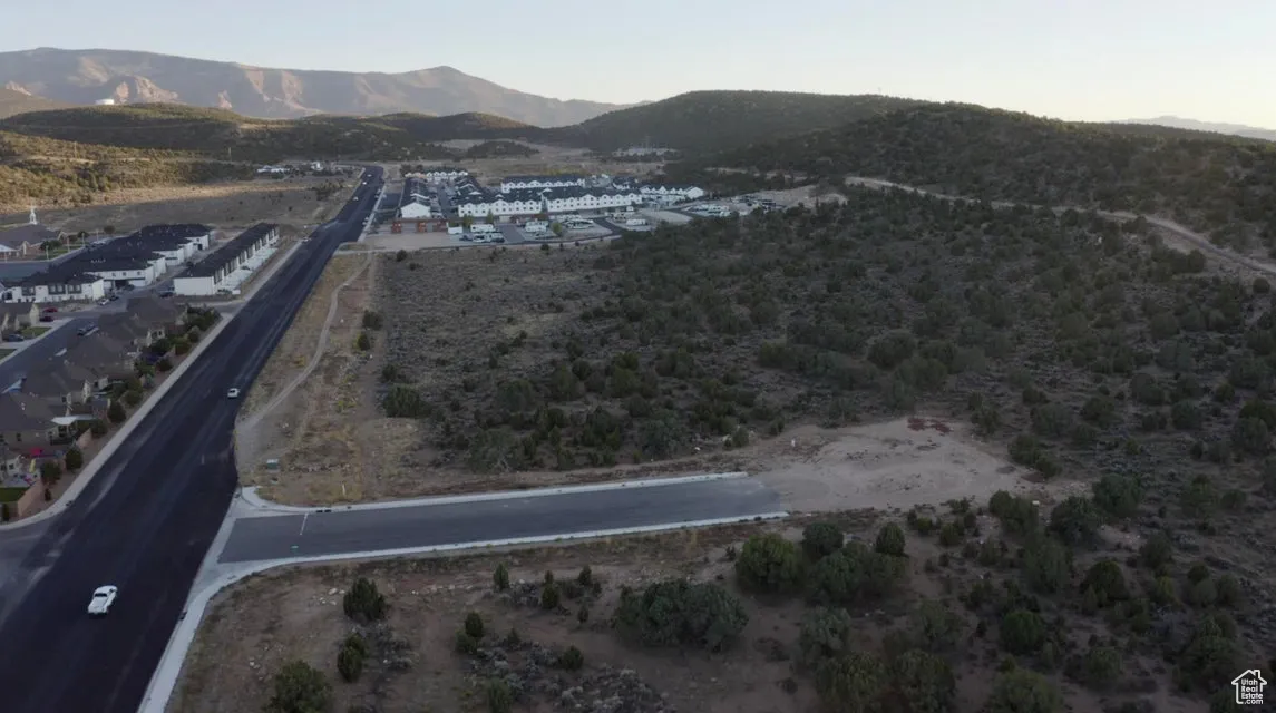 Aerial view of property's location featuring a mountain backdrop