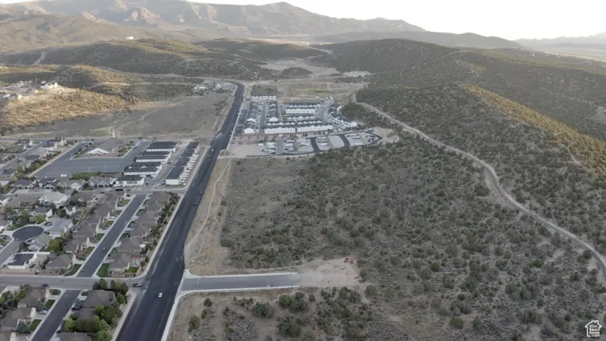 Aerial view of property and surrounding area with a mountainous background