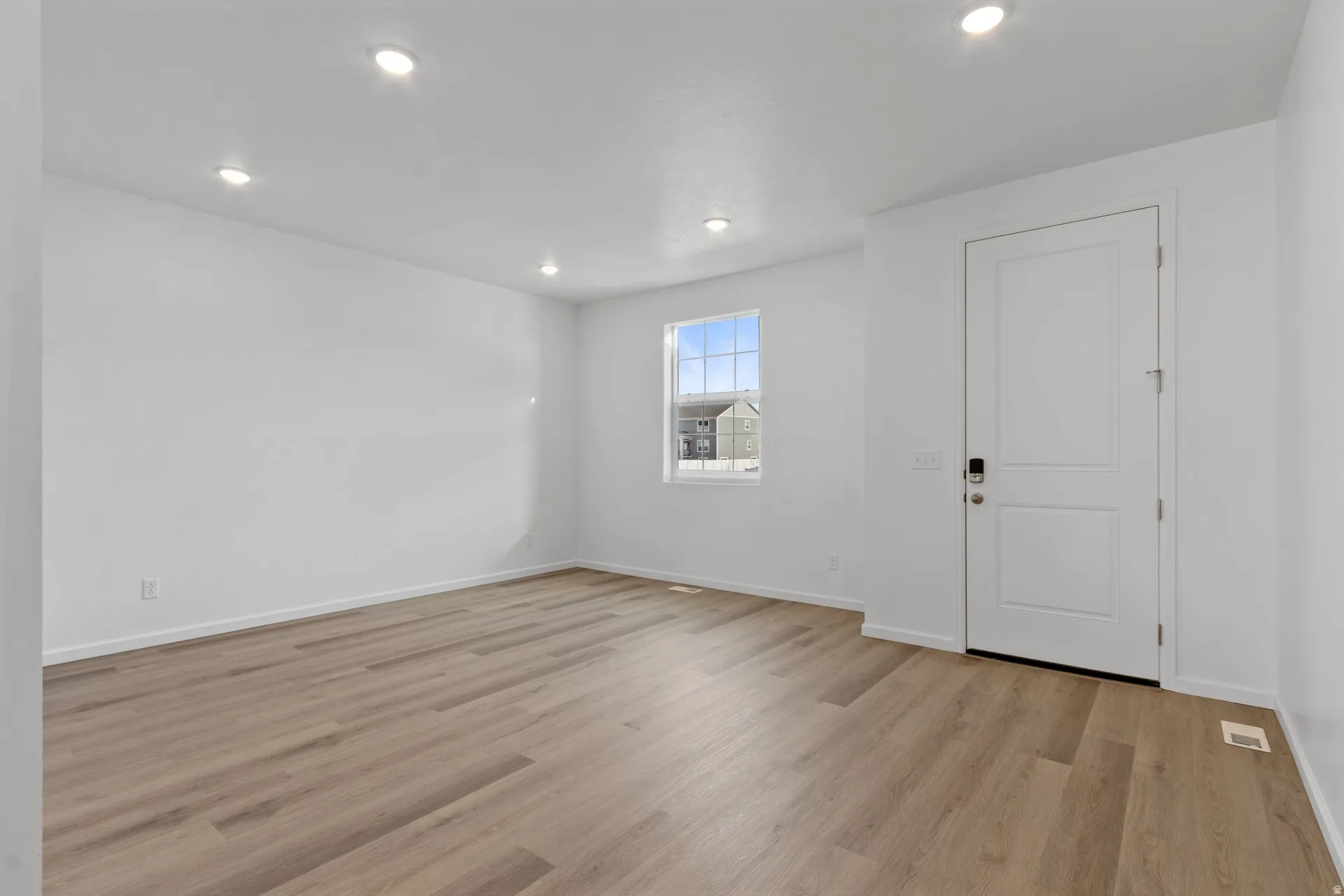 Front bonus room with light wood-style floors and recessed lighting