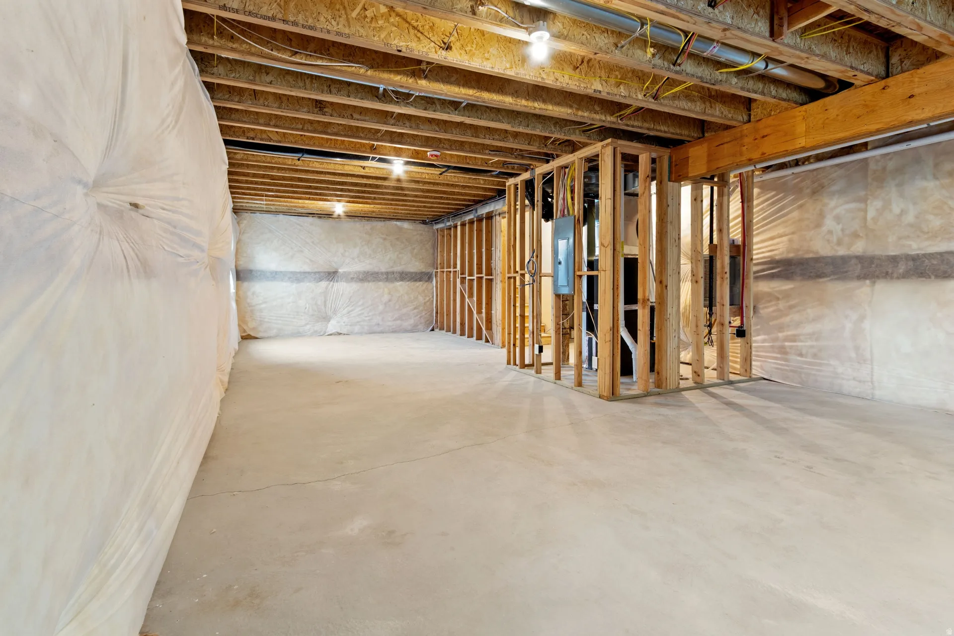 Unfinished basement featuring electric panel