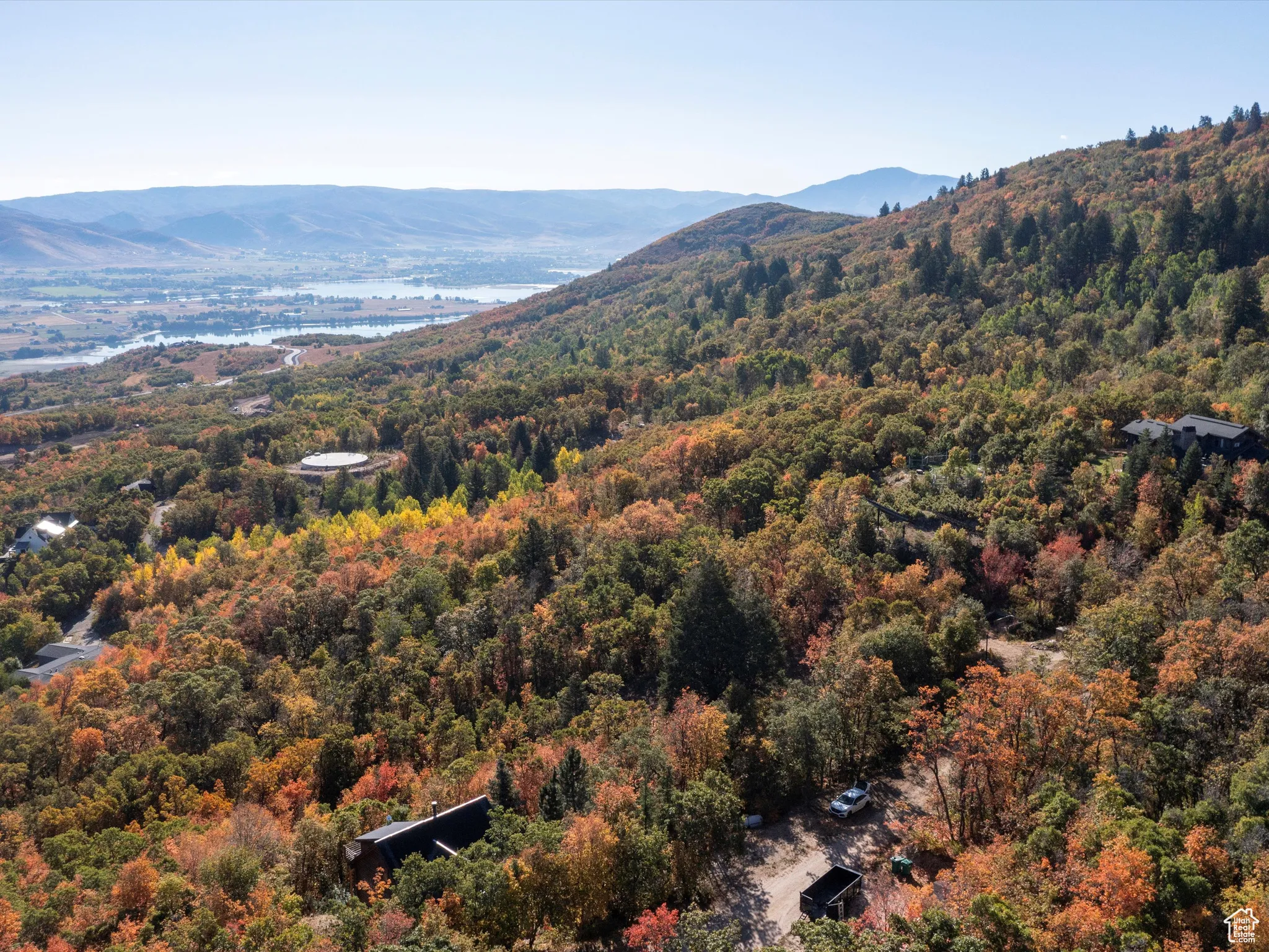Mountain view featuring a large body of water and a forest