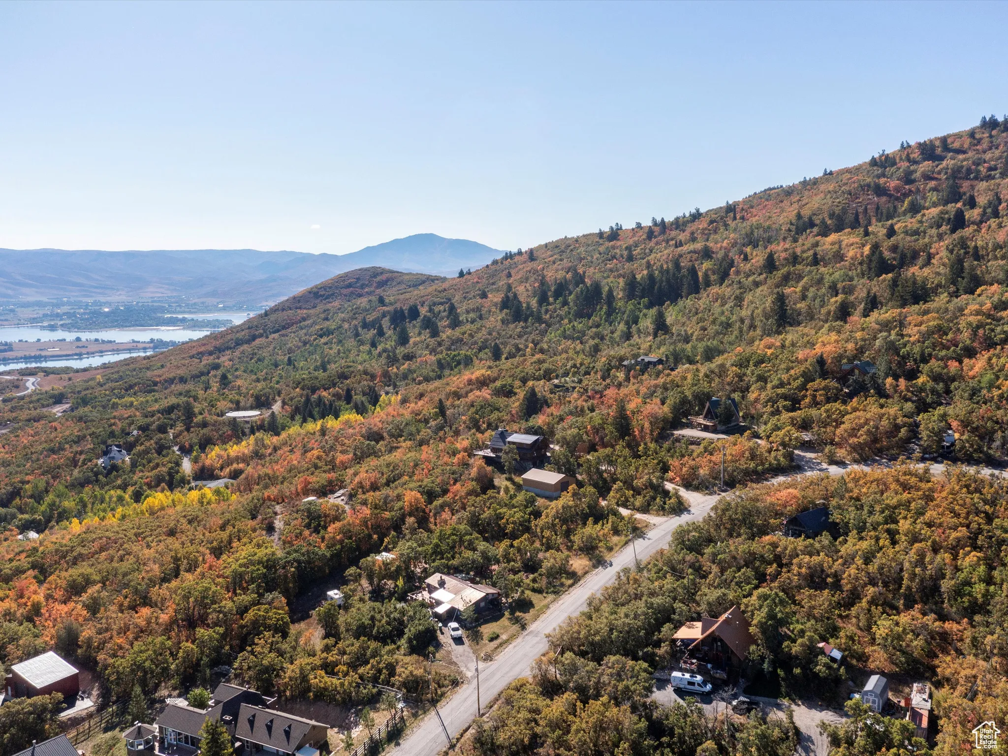 Bird's eye view of a water and mountain view and a heavily wooded area