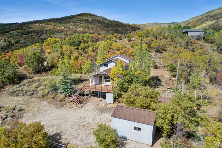 Aerial view of property and surrounding area with a mountainous background