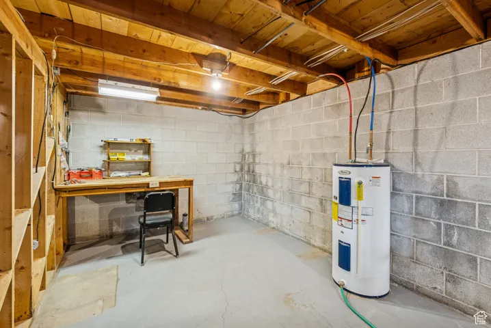 Unfinished below grade area featuring water heater