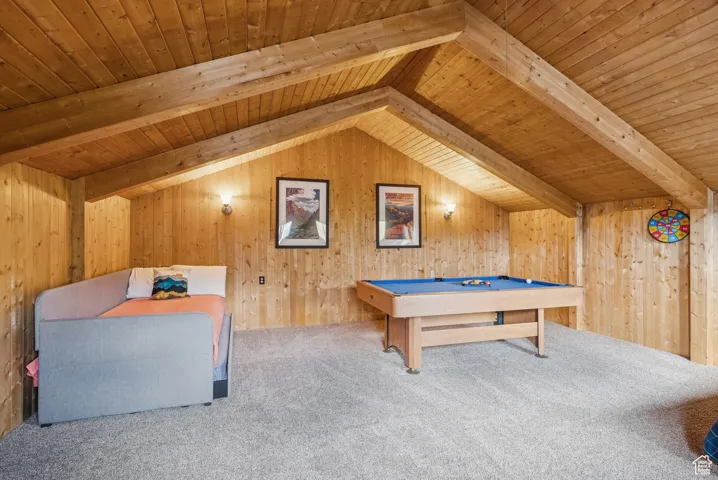 Playroom with carpet floors, wooden ceiling, pool table, and wooden walls