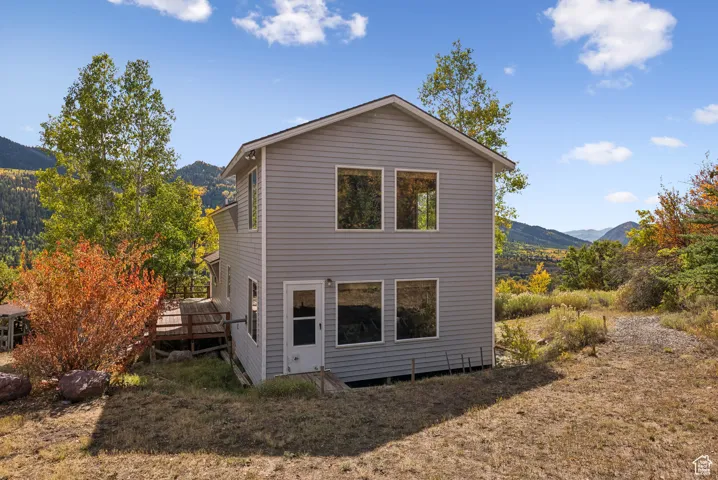 Back of house featuring a deck with mountain view