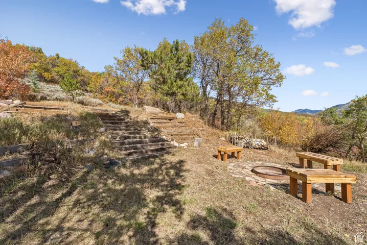 View of yard with an outdoor fire pit