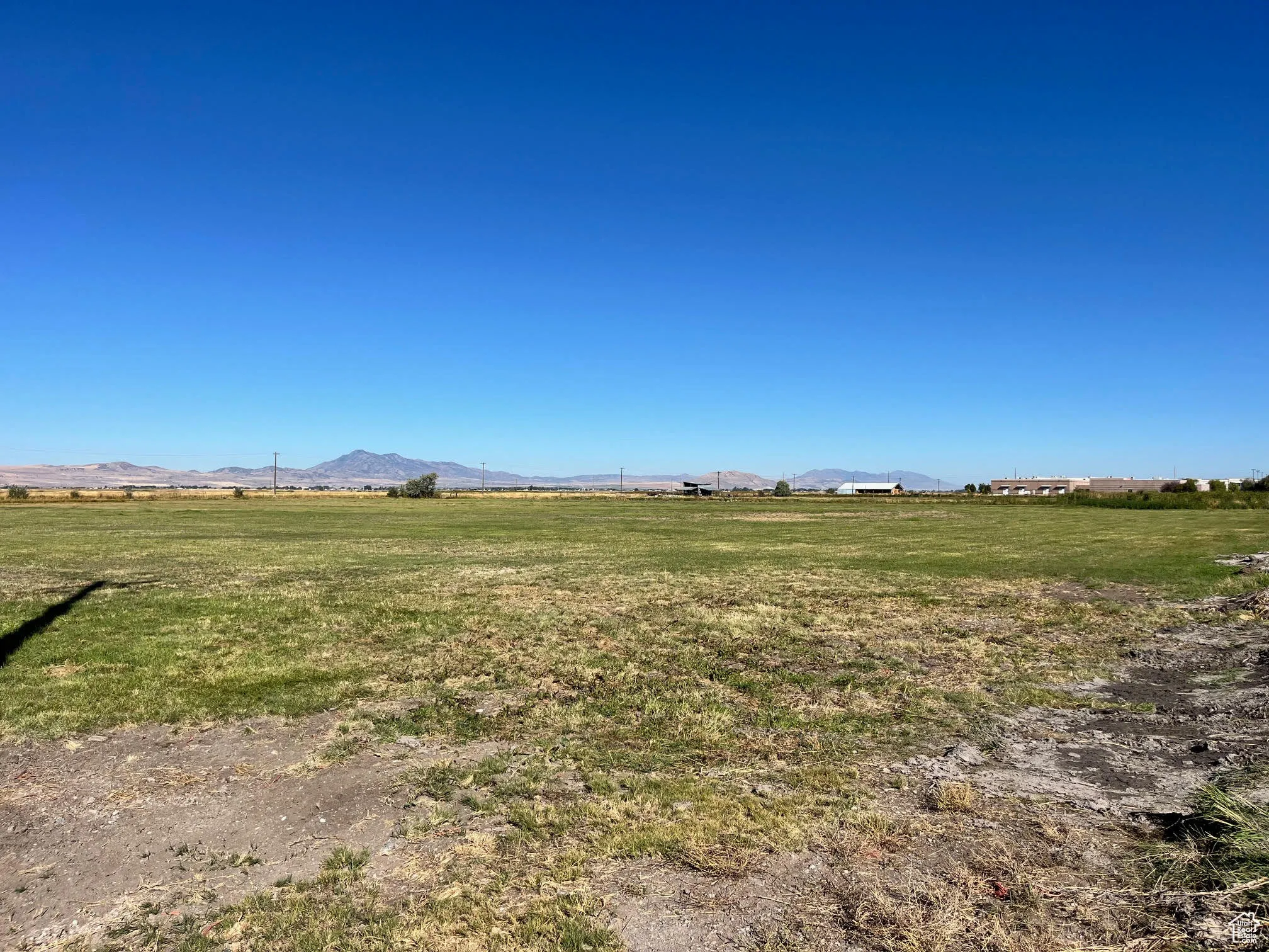 View of grassy yard with a view of countryside and a mountain view