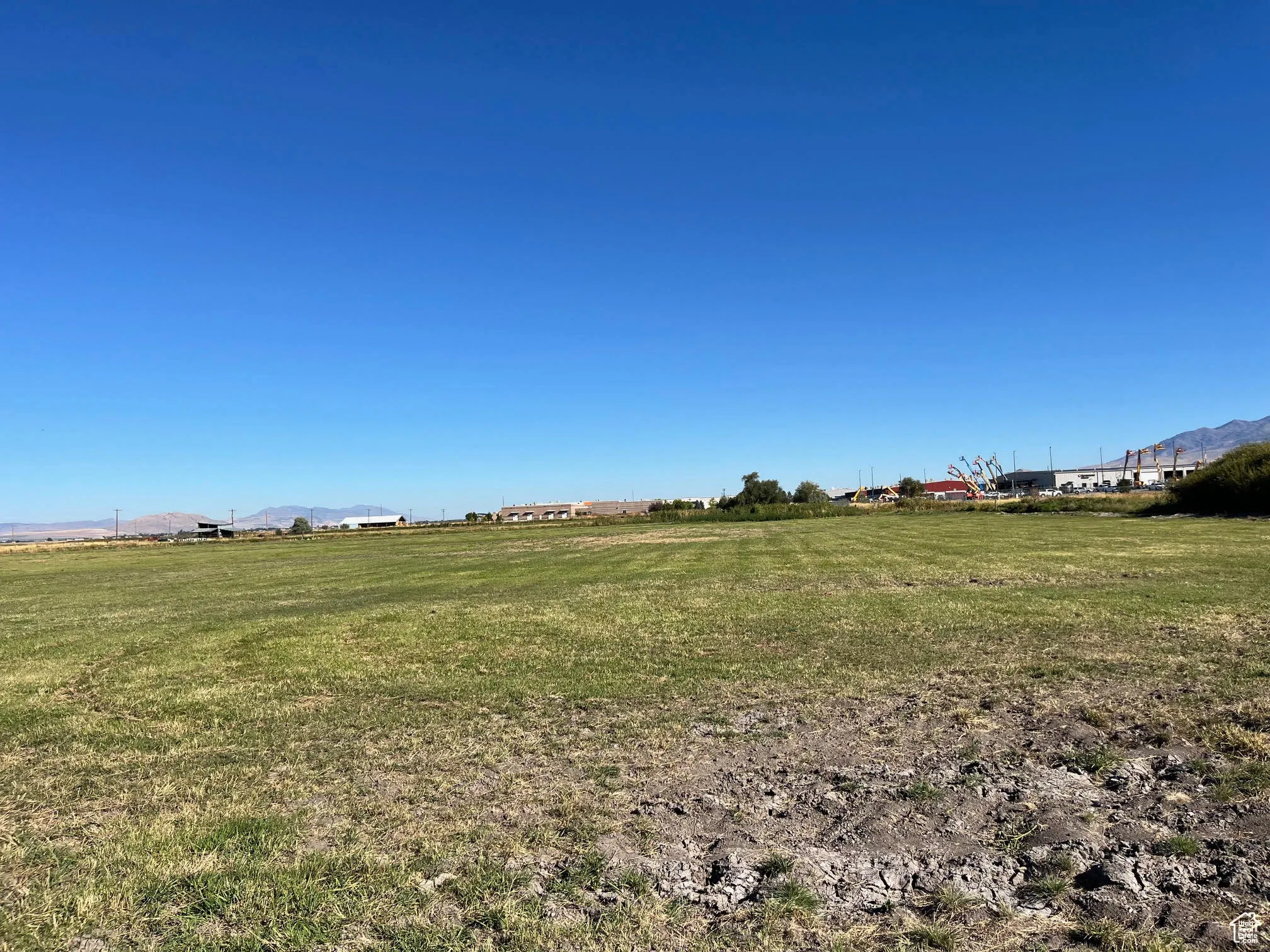 View of green lawn with a mountain view and a view of rural / pastoral area
