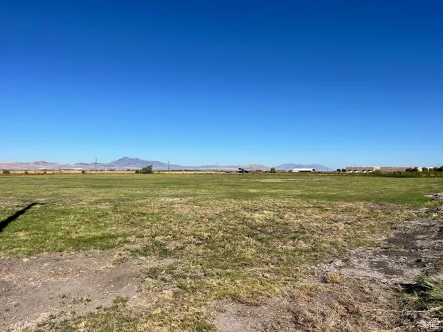 View of grassy yard with a view of countryside and a mountain view