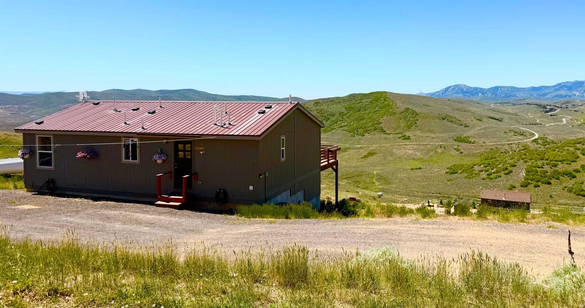 Single-story residence featuring a red metal roof and neutral siding