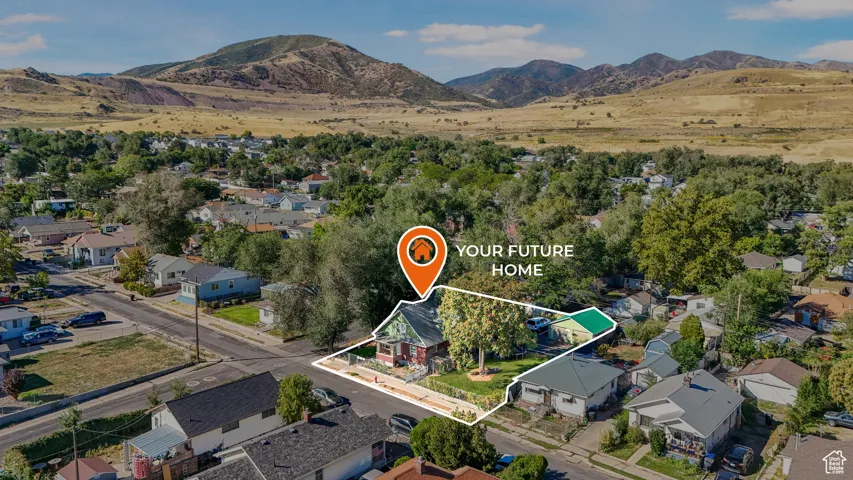 Aerial perspective of suburban area with a mountain backdrop and property boundaries highlighted