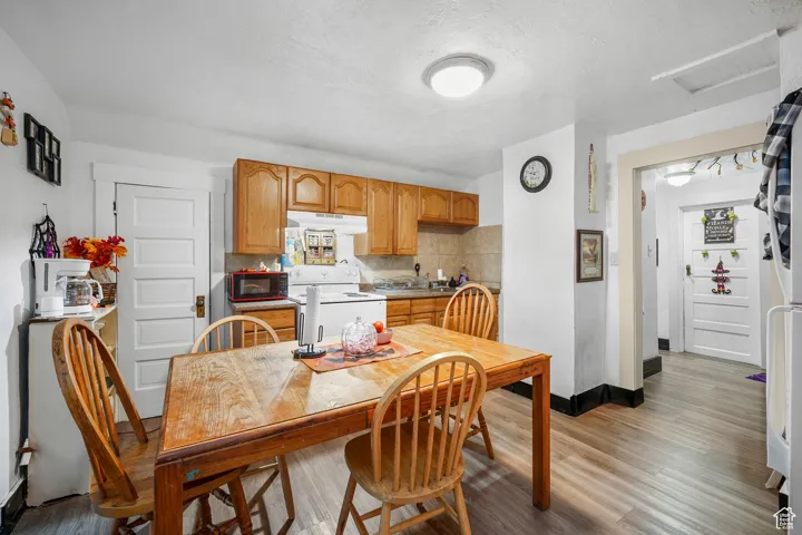Dining room with light wood-style flooring and a textured ceiling
