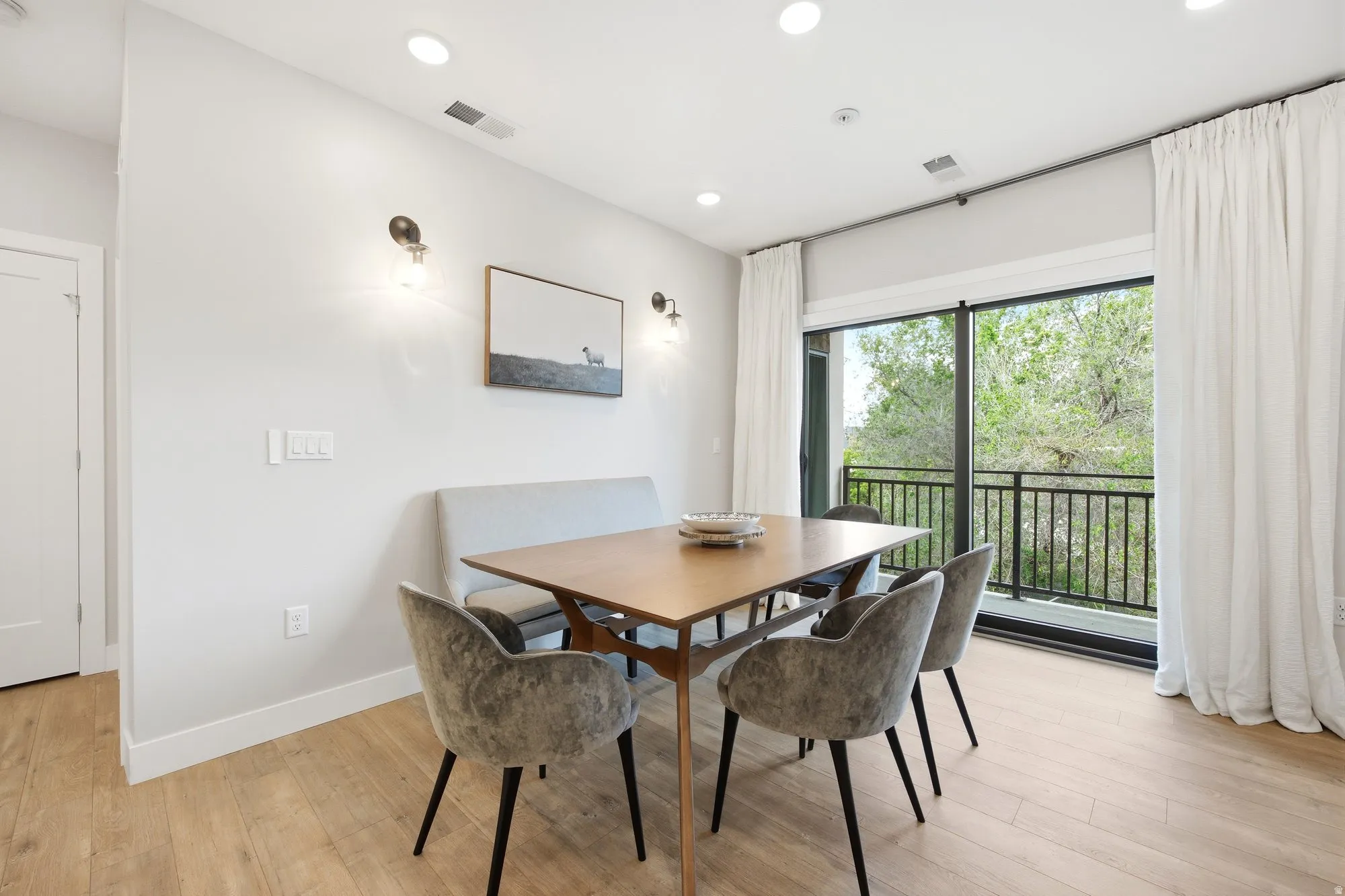 Dining area with recessed lighting and light wood-type flooring