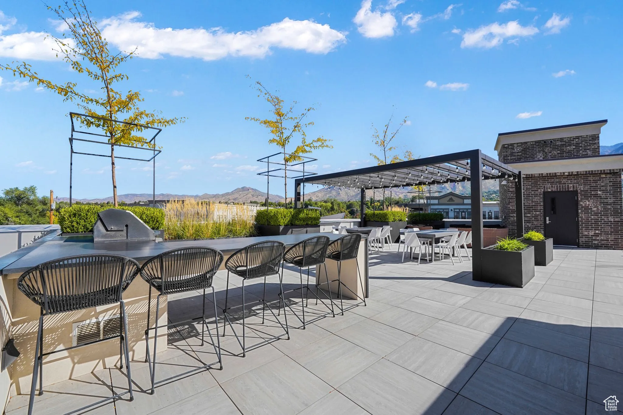 View of Patio / Terrace Featuring Area For Grilling, Mountain Views, and a Pergola