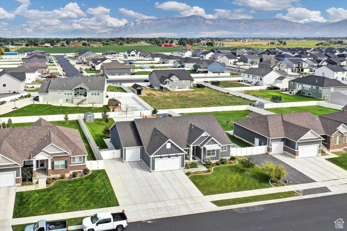 Aerial view of residential area featuring a mountainous background