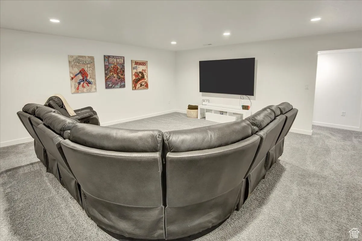 Living room with recessed lighting and light colored carpet