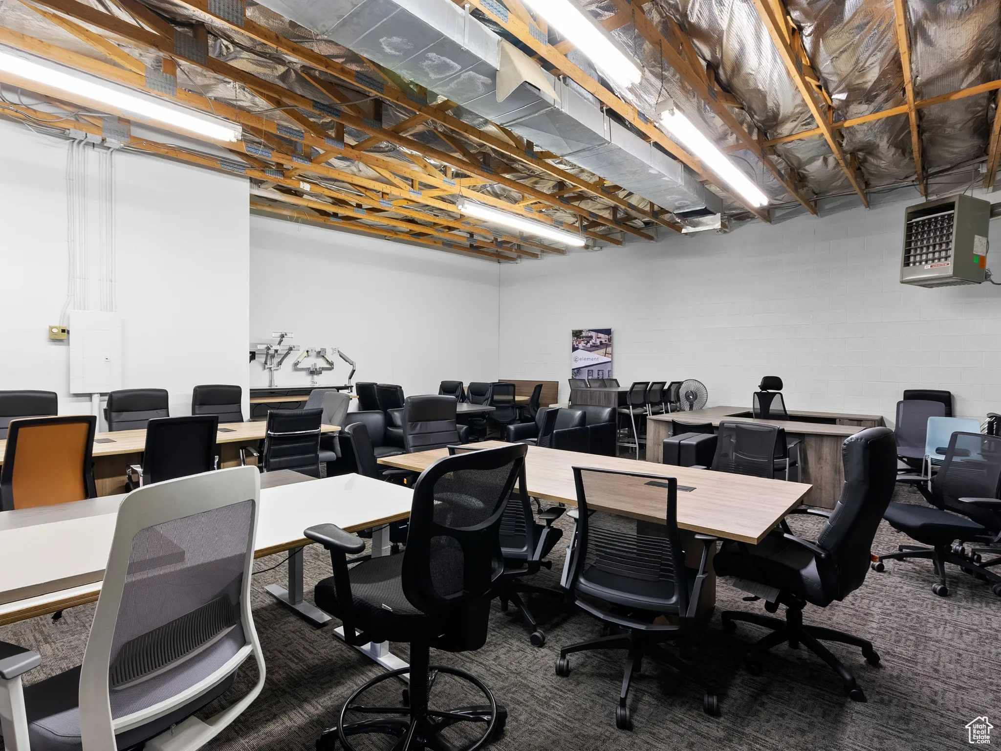 Carpeted office featuring a heating unit