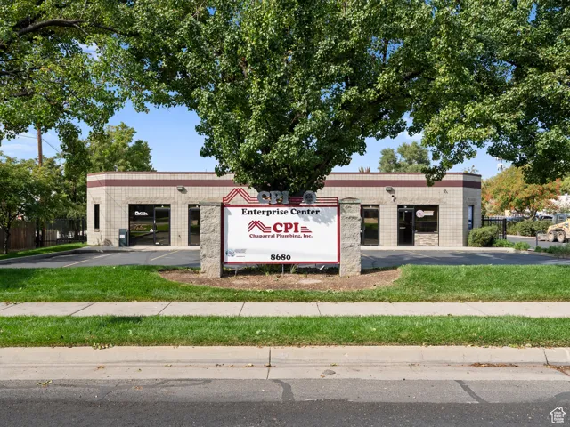 Community sign featuring uncovered parking