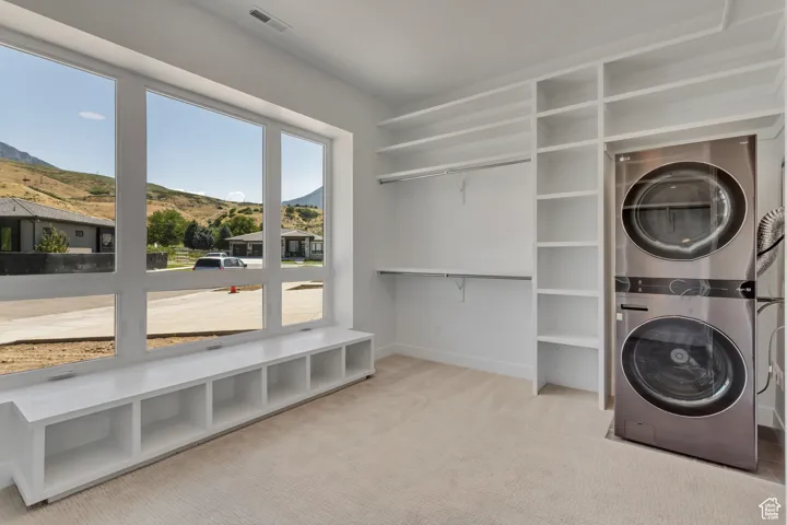 Primary Closet featuring stacked washer / drying machine.